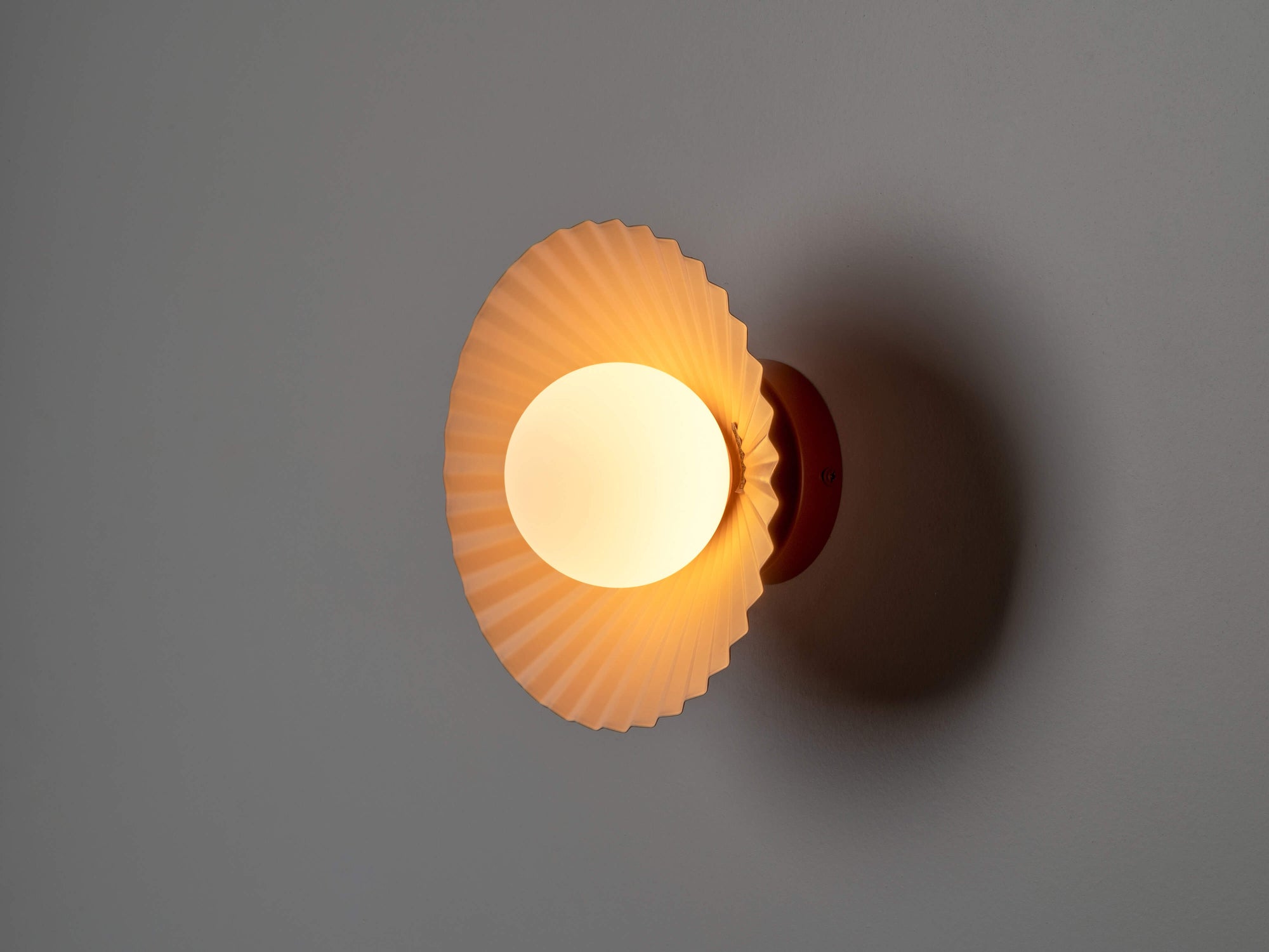 Burnt orange flush pleat wall light