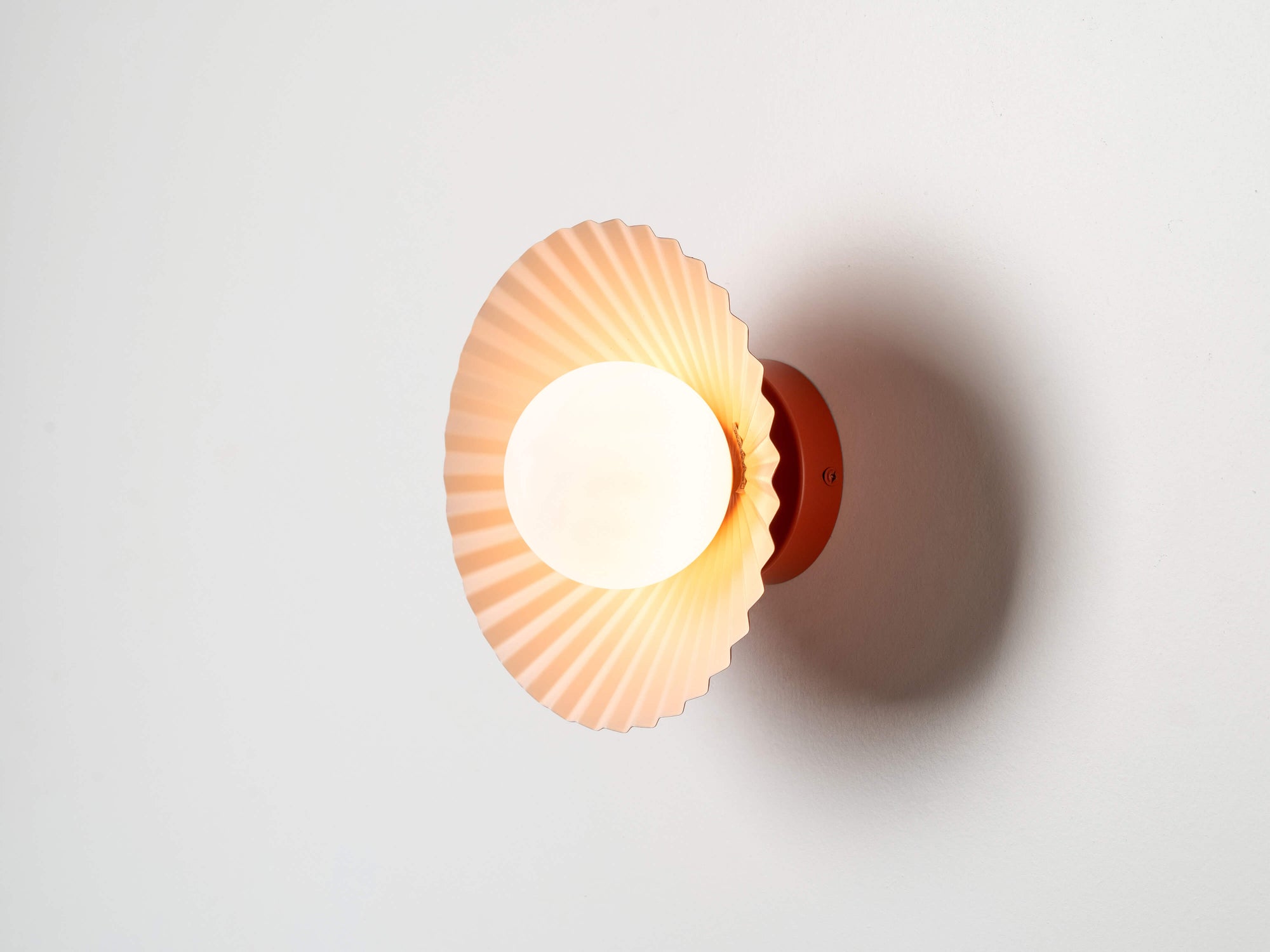 Burnt orange flush pleat wall light